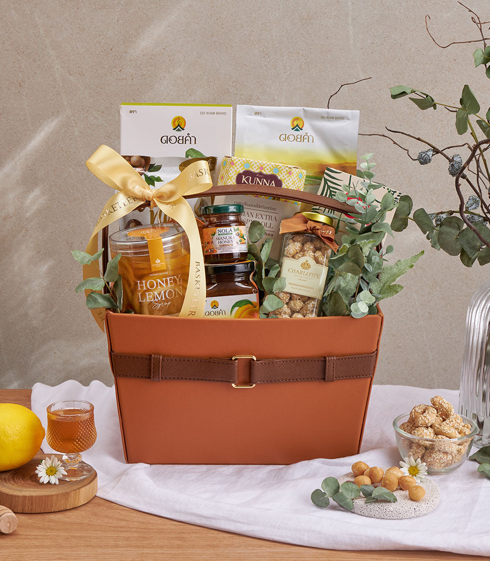 Premium wellness gift basket with honey, manuka honey, Charlotte snacks, and gourmet treats in faux leather hamper