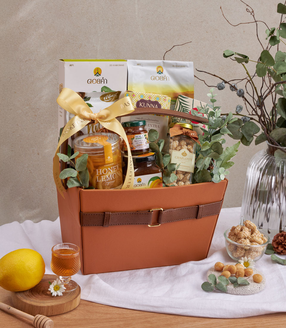 Burnt orange leather wellness gift basket with manuka honey, artisan syrups, mulberries, and gourmet treats