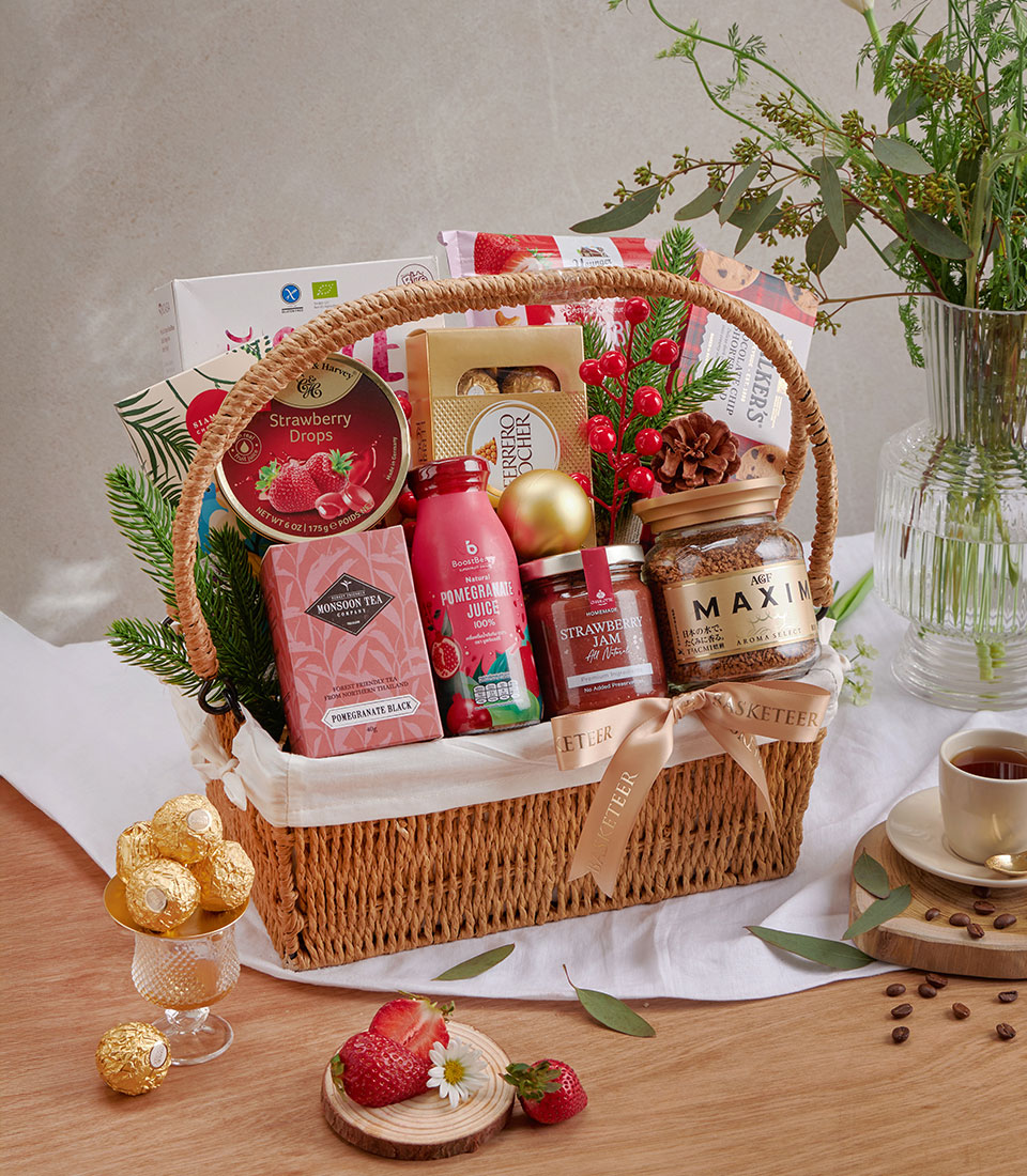 Woven gift basket with strawberry drops, gourmet chocolates, pomegranate juice, strawberry jam, and premium coffee