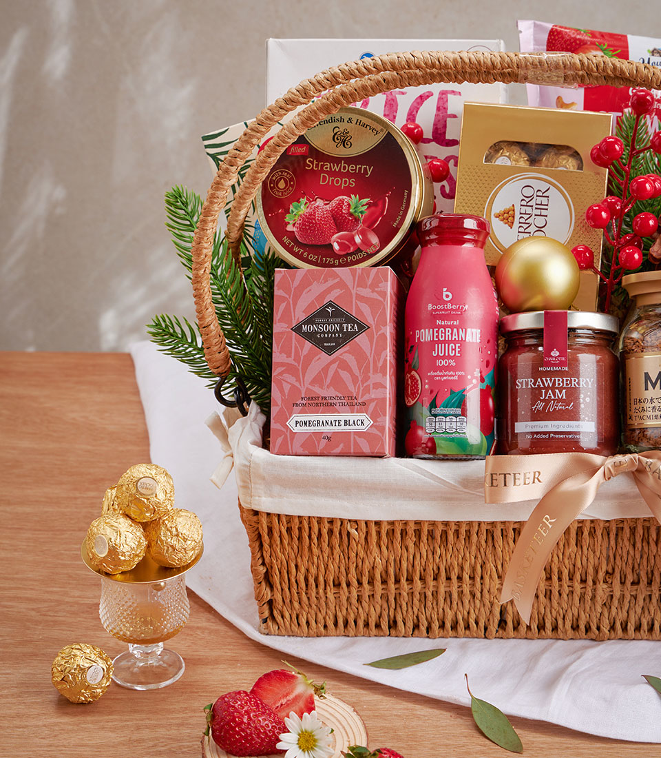 Premium woven gift basket with strawberry drops, pomegranate tea, gourmet jam, and Ferrero Rocher chocolates