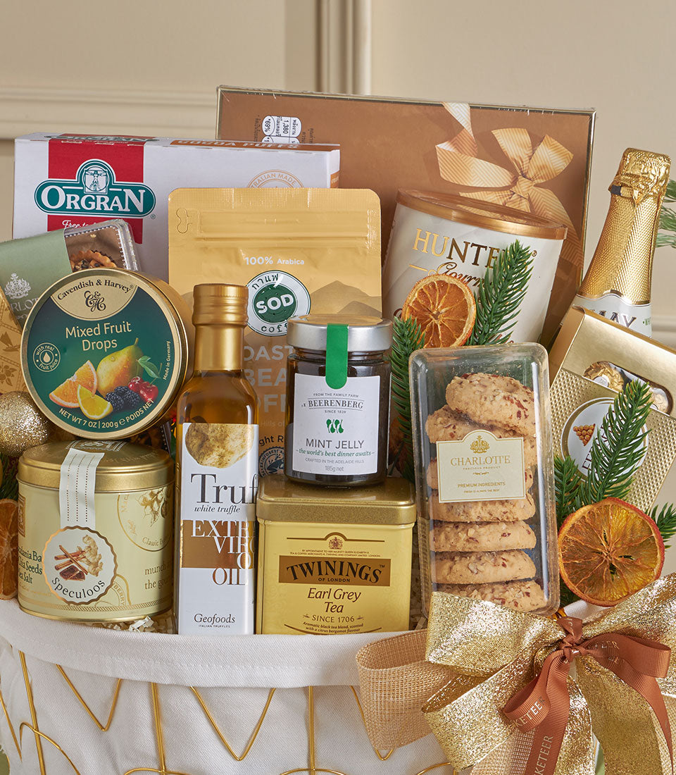 Luxury gold gourmet gift basket with premium coffee, olive oil, tea, and sparkling wine for New Year celebrations
