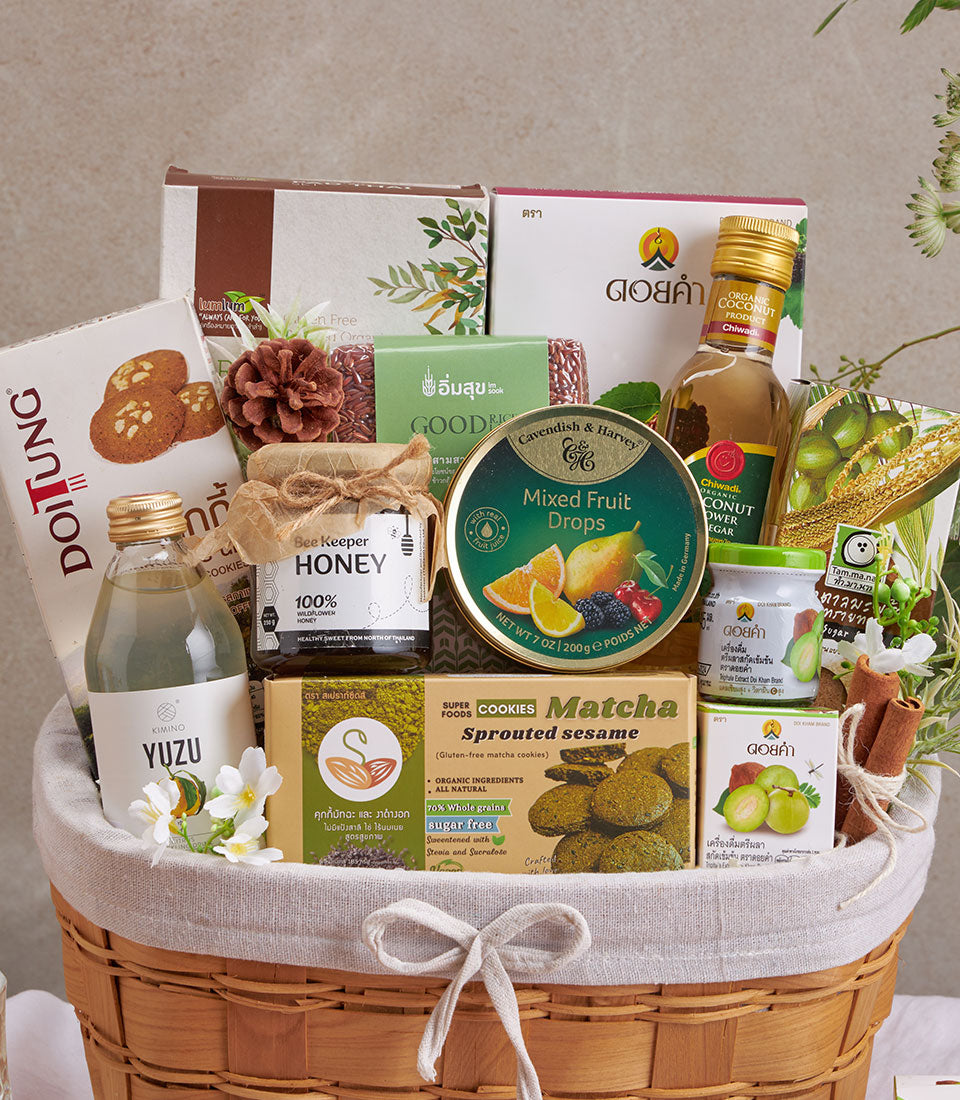 Premium wellness gift basket with organic superfoods, honey, yuzu drink, and artisan treats in woven cream hamper