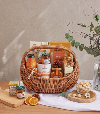 Woven wicker wellness gift basket with organic honey, juice, psyllium husk, nuts, and coconut wafers