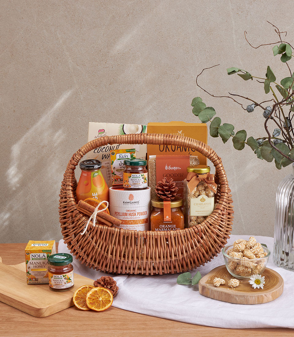 Woven wicker wellness gift basket with organic honey, juice, psyllium husk, nuts, and coconut wafers