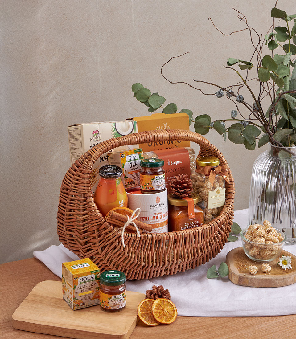Woven wicker wellness gift basket with organic psyllium husk, manuka honey, marmalade, and gourmet pantry essentials