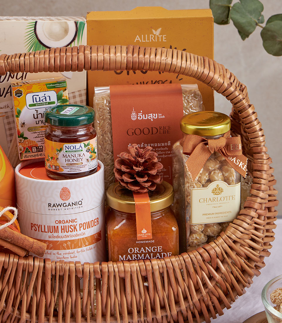 Woven wicker wellness gift basket with organic honey, psyllium husk, brown rice, marmalade, and sesame snacks