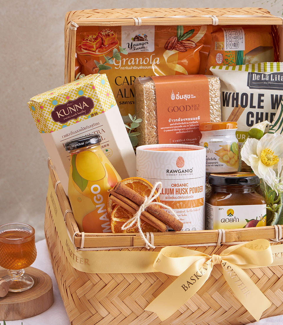 Premium wellness gift basket with organic granola, brown rice, psyllium husk powder, honey, mango juice and dried citrus in