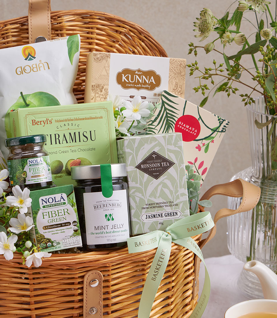 Premium woven wellness gift basket with green tea, herbal supplements, and gourmet treats