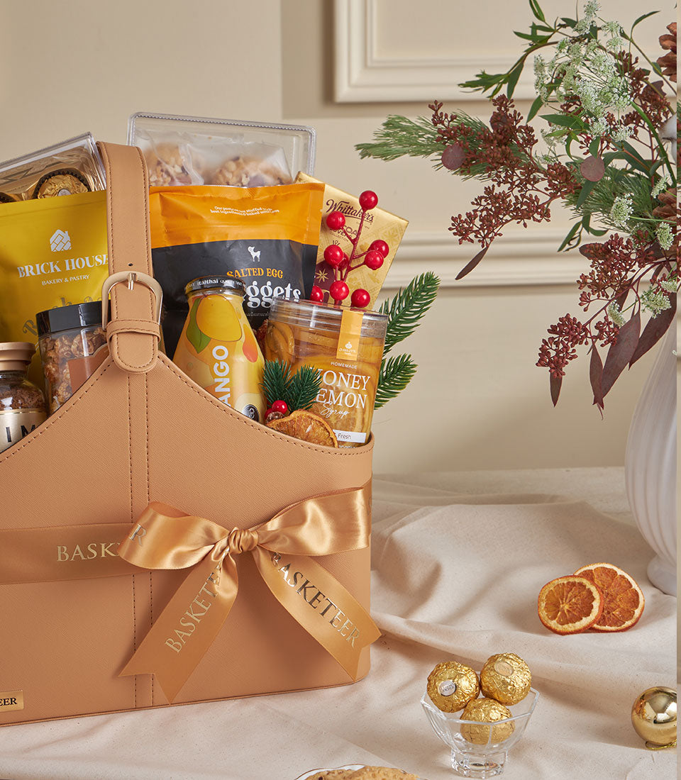 Mango Sunrise luxury gourmet tote with mango juice, salted egg snacks, honey lemon syrup, and Whittaker's chocolate in faux