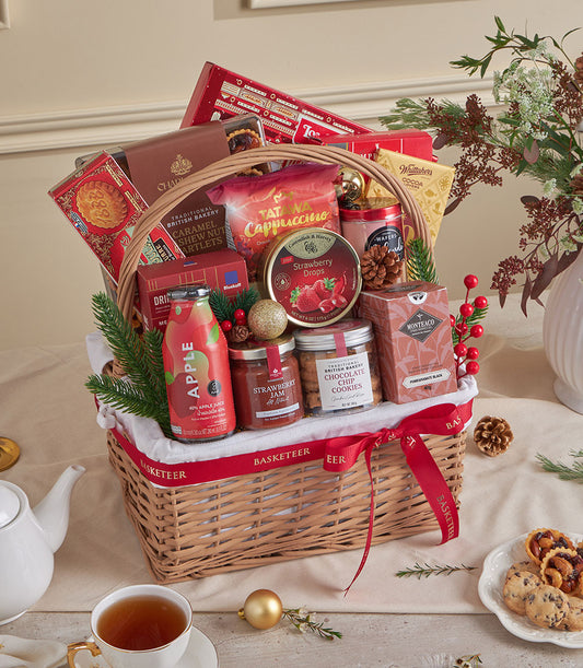 Red velvet wicker gift hamper with gourmet treats, jam, tea, and festive gold accents for New Year celebrations