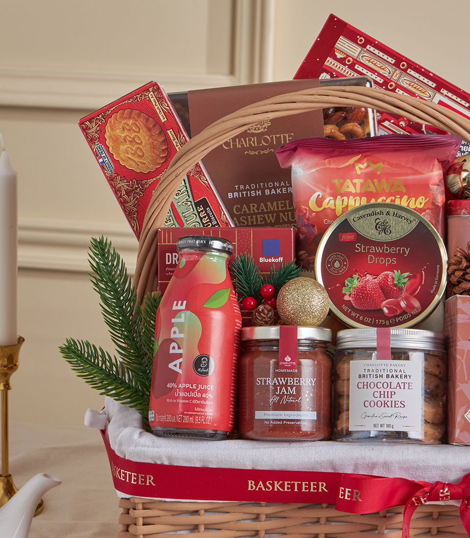 Red velvet gourmet hamper with biscuits, caramel nuts, jam, and festive decorations for New Year gifting