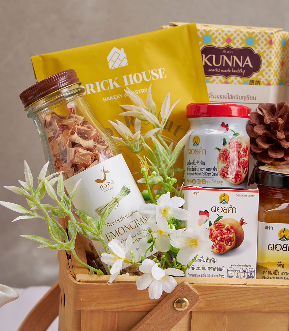Premium wellness gift basket with lemongrass tea, healthy snacks, and herbal infusions in woven wood hamper