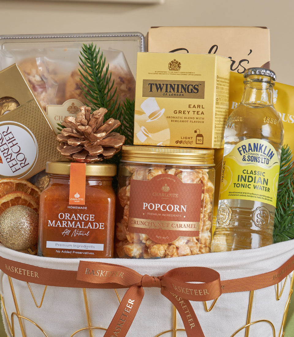 Premium almond and citrus gourmet basket with Earl Grey tea, marmalade, and caramel popcorn for New Year gifting