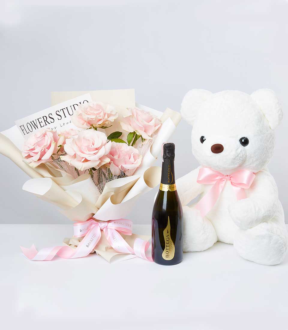 Luxury gift set with pale pink roses, Bottega Prosecco, and plush teddy bear with pink ribbon