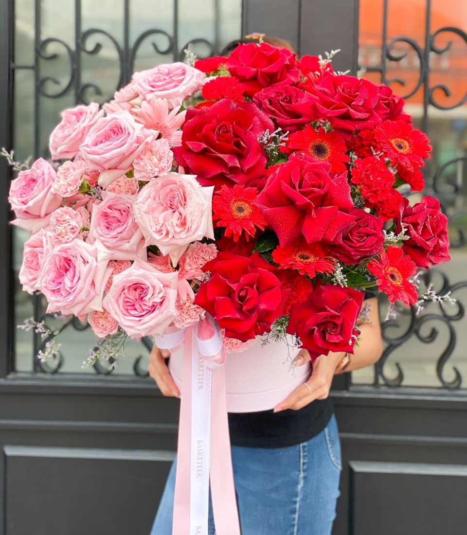 Romantic pink and red roses in luxury hatbox with fresh blooms for birthday celebrations