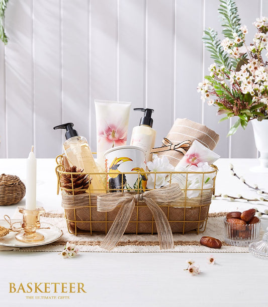 Luxury spa gift basket with bath products, lotion, soap, and beige accents in gold wire holder