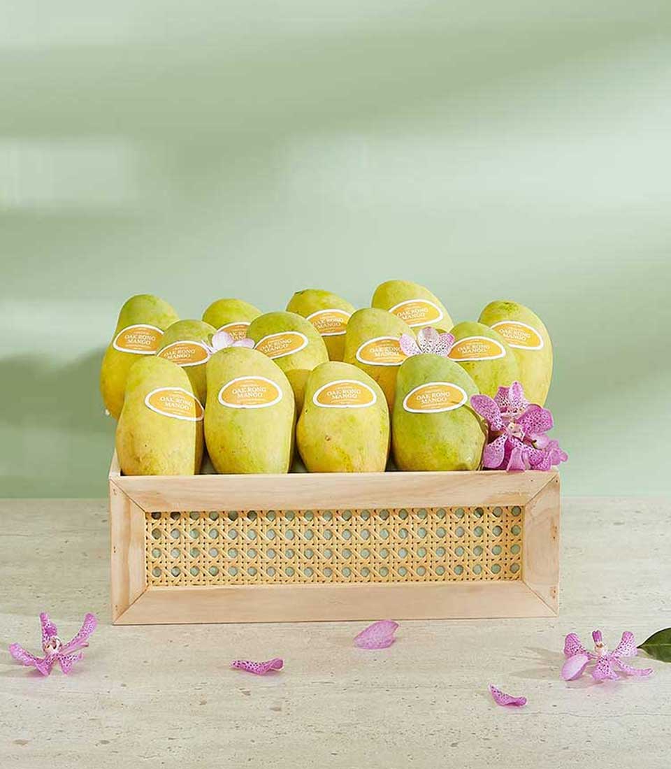 Premium Oak Rong mango gift box with tropical fruit and orchid garnish, natural wood presentation