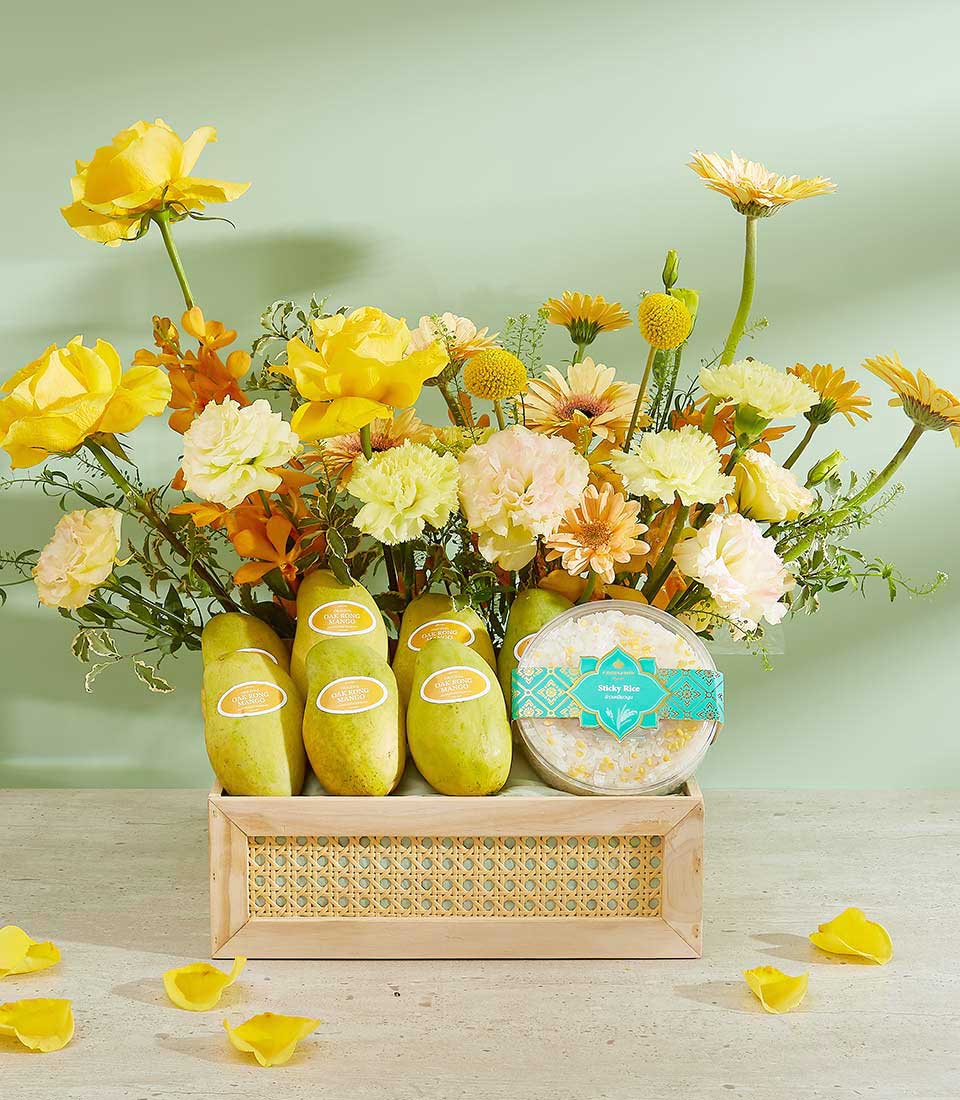 Tropical Bliss luxury gift basket with yellow and orange roses, fresh Thai mangoes, and sticky rice dessert