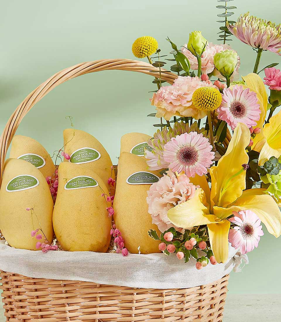 Premium Thai mango gift basket with pink carnations and yellow lilies in woven wicker