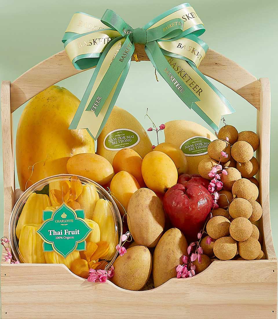 Wooden tropical fruit gift basket with papayas, mangoes, jackfruit, and longans, tied with cream Basketeer ribbon