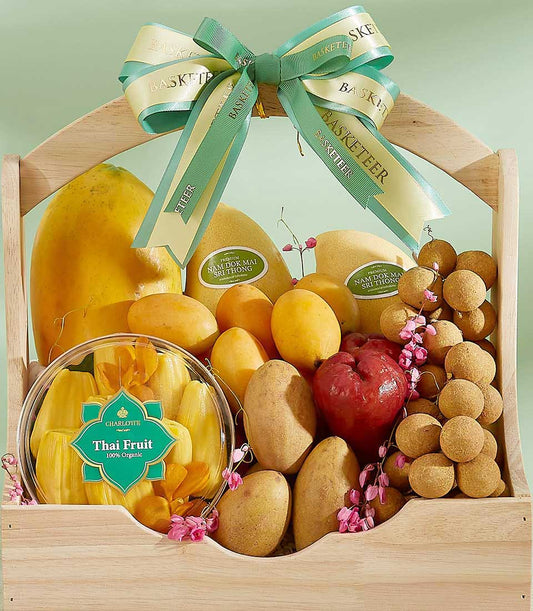 Wooden tropical fruit gift basket with papayas, mangoes, jackfruit, and longans, tied with cream Basketeer ribbon