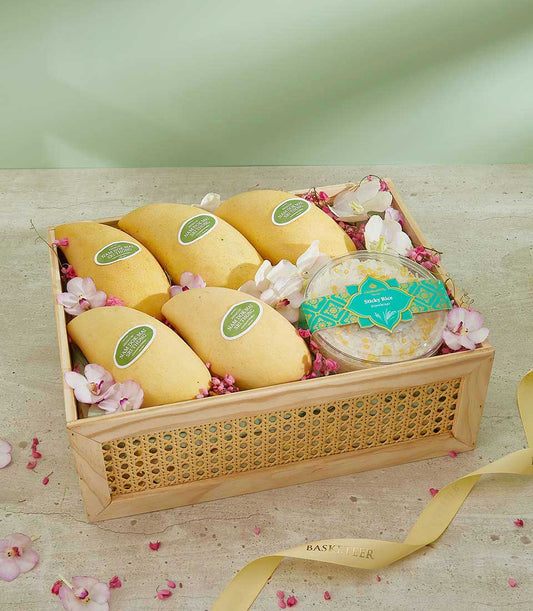 Summertime Mango Surprise Box with Nam Doc Mai mangoes, sticky rice, and orchid florals in woven cane gift box