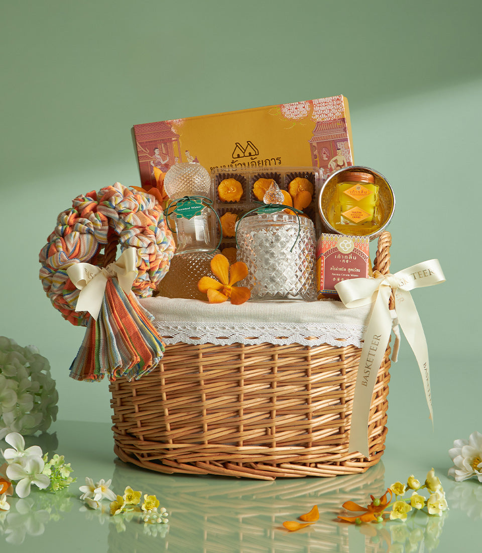 Heritage Songkran gift basket with Thai sweets, scented water, and traditional treats in woven wicker