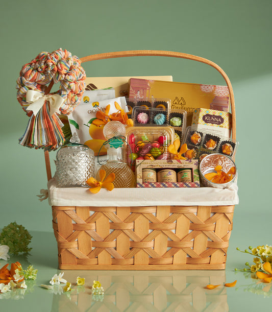 Golden Thai Essence woven basket with scented water, artisan sweets, and fresh orchids for Songkran celebration