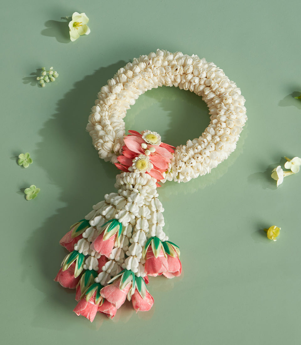 Traditional Thai jasmine Phuang Malai garland with cascading pink blooms for Songkran celebration