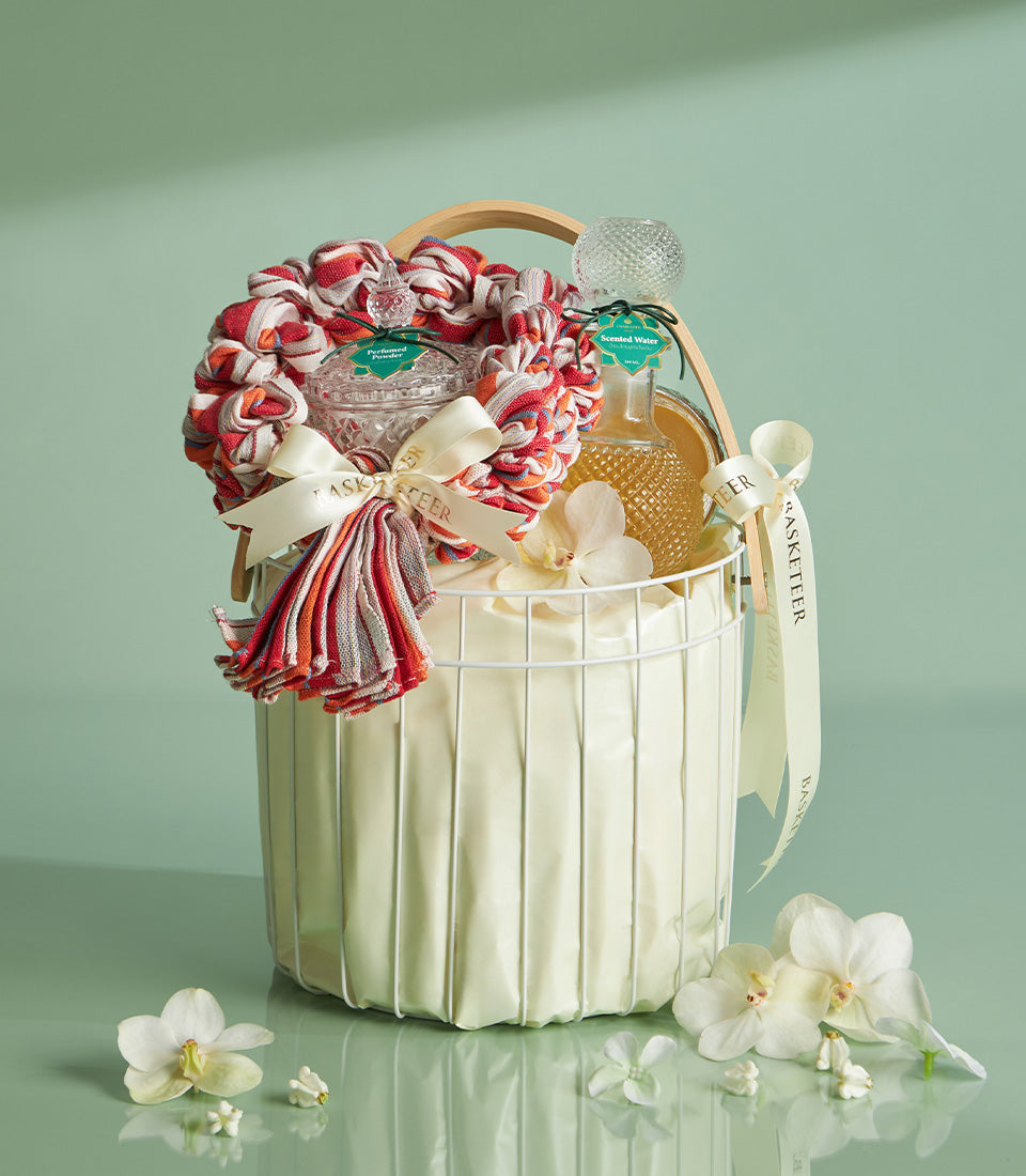 Traditional Thai Songkran blessing gift basket with perfumed powder, scented water, and white orchids