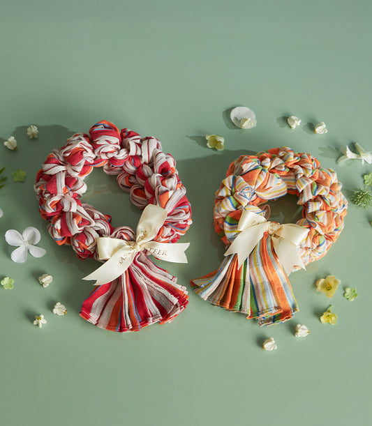 Pha-kao-ma Thai loincloth garland wreaths with striped fabric and satin bows for Songkran celebration gifts