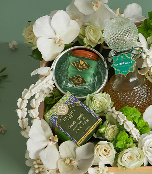 Songkran floral blessing gift set with white orchids, roses, and aromatic wellness products in wooden box