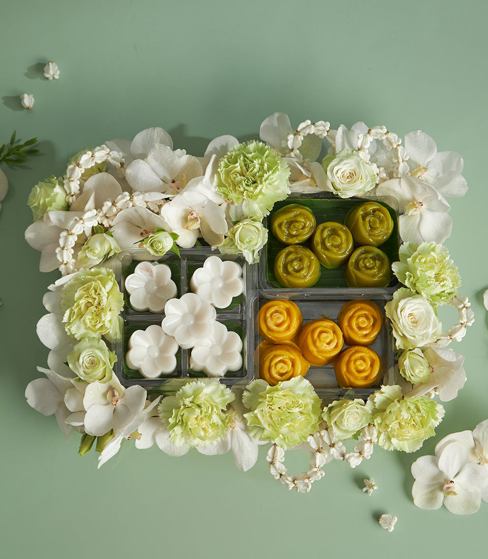 Thai dessert gift box with white orchids, light green carnations, and roses for Songkran celebration