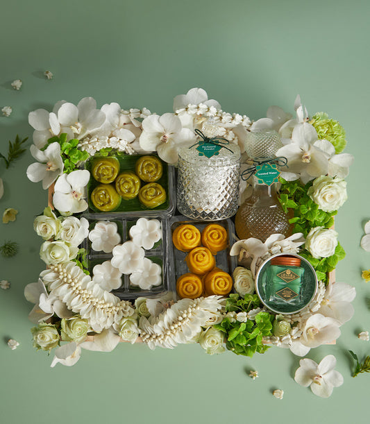 Thai sweets and fresh flower gift box for Songkran celebration with floral desserts, scented water, and white orchids