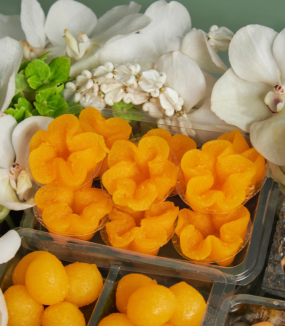 Thai auspicious golden desserts with white orchids in luxury gift set for Songkran celebration