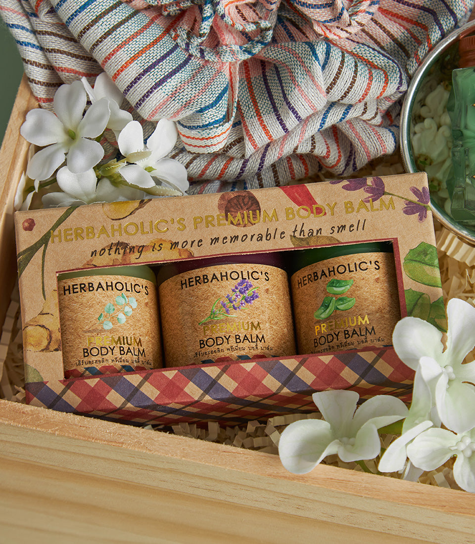 Prosperous Thai gift box with three Herbaholic's premium body balms, wooden crate, and artisanal botanicals for Songkran