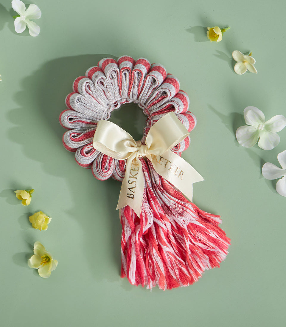 Red and white striped Thai garland with satin bow, Songkran New Year celebration ornament