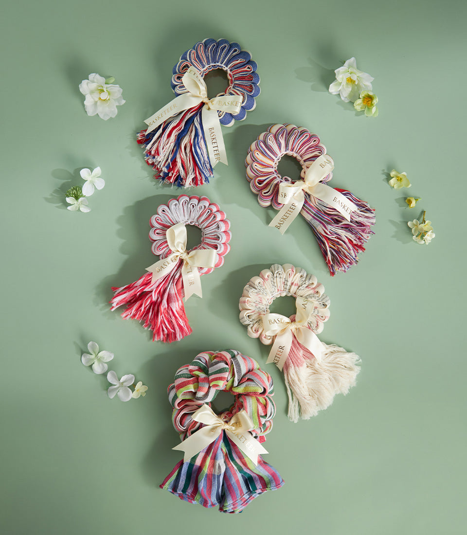 Colorful Pha-Kao-Ma Thai fabric garland ornaments in striped and floral patterns with cream ribbons