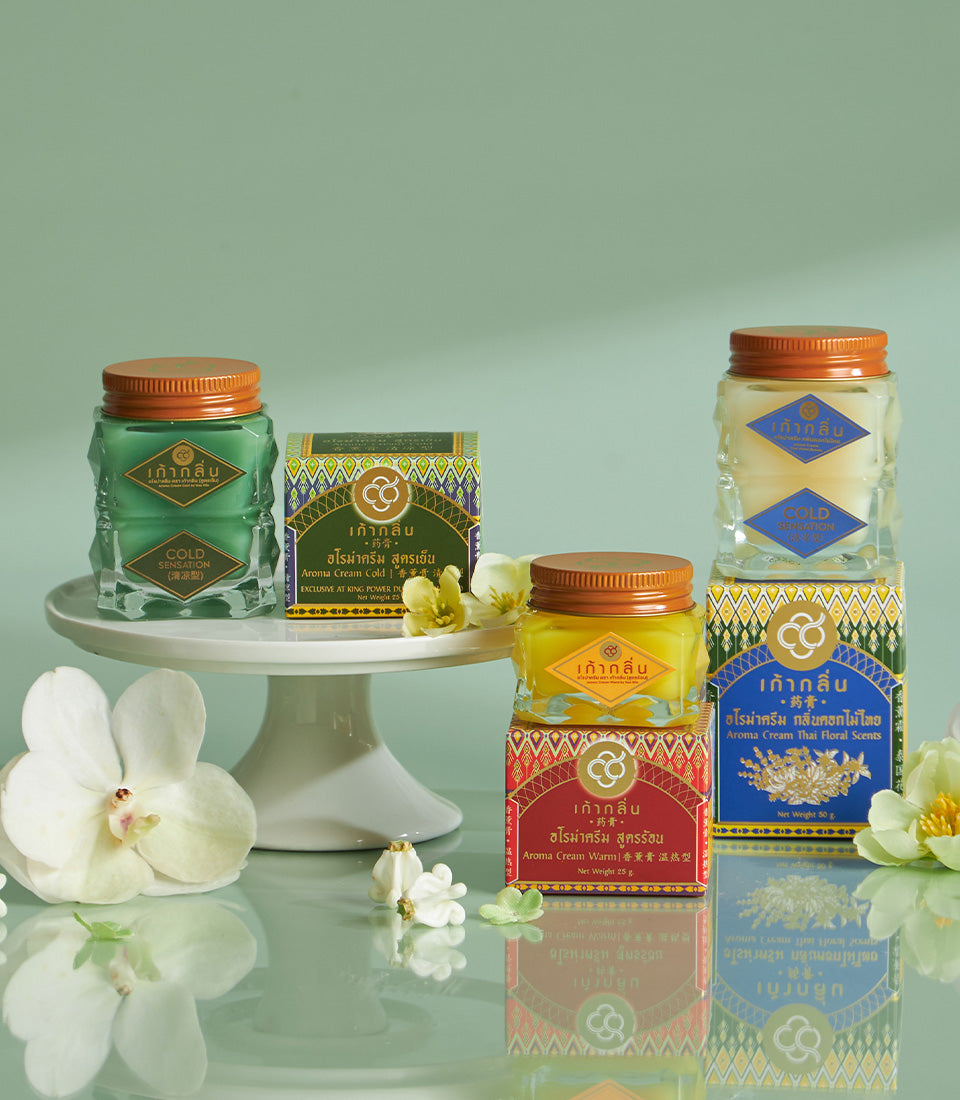 Thai Songkran blessing gift basket with aroma creams, glass jars, and orchids in gold-patterned boxes