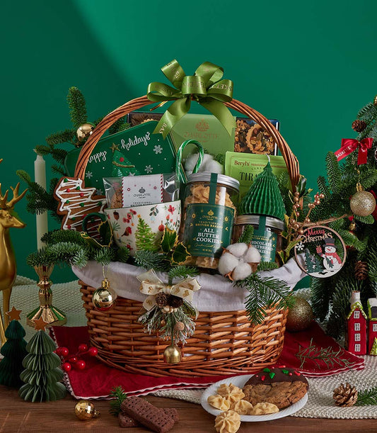 Woven wicker Christmas gift basket with premium butter cookies, chocolate shortbread, festive mug, and holiday treats tied