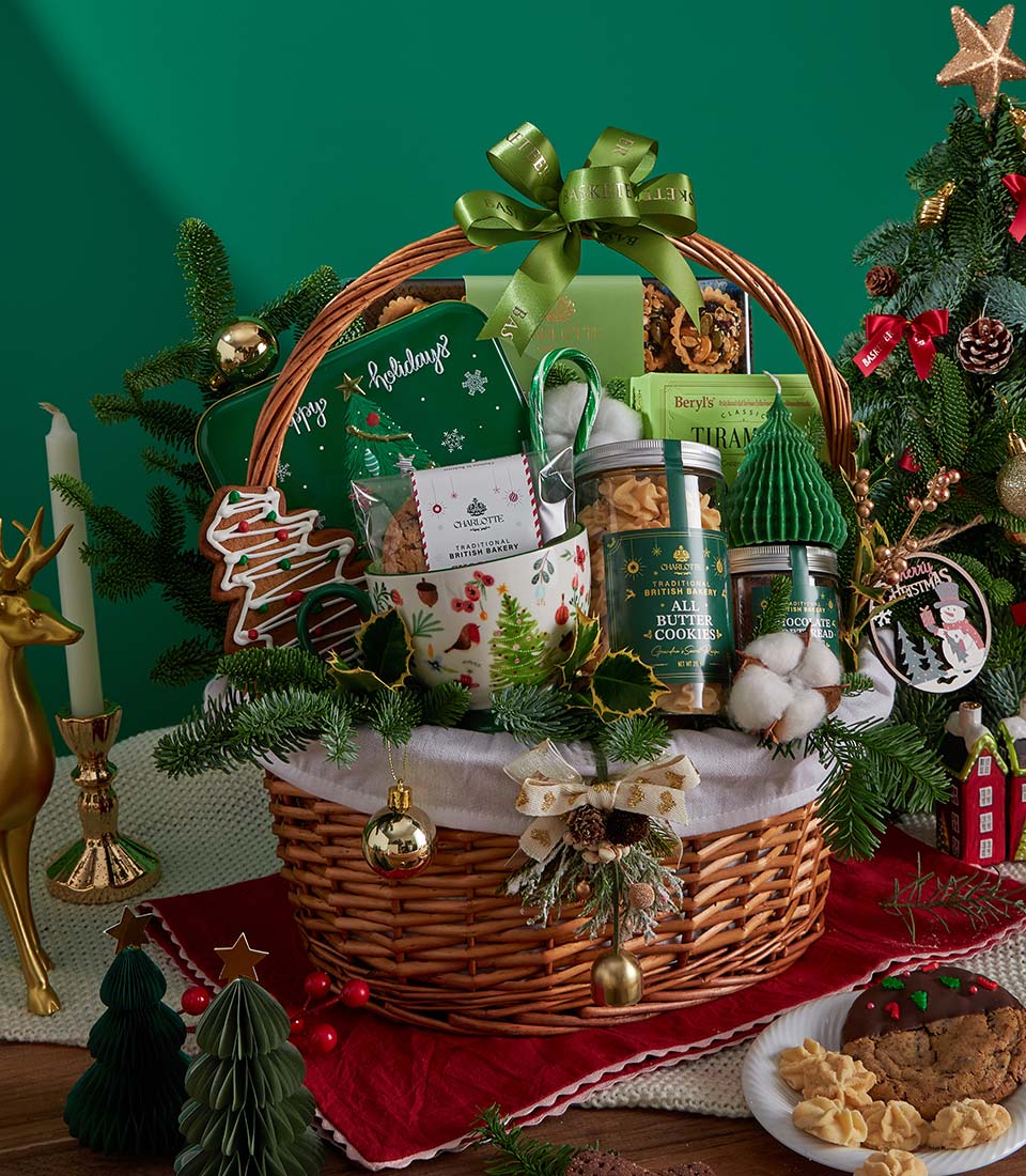 Premium Christmas gift basket with butter cookies, chocolate spread, and festive treats in wicker with green ribbon