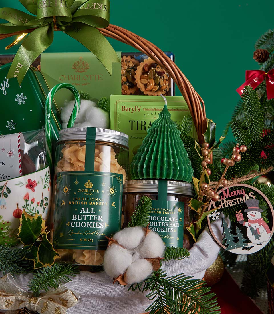 Festive Christmas gift basket with British butter cookies, chocolate shortbread, premium chocolates, and holiday candle tied