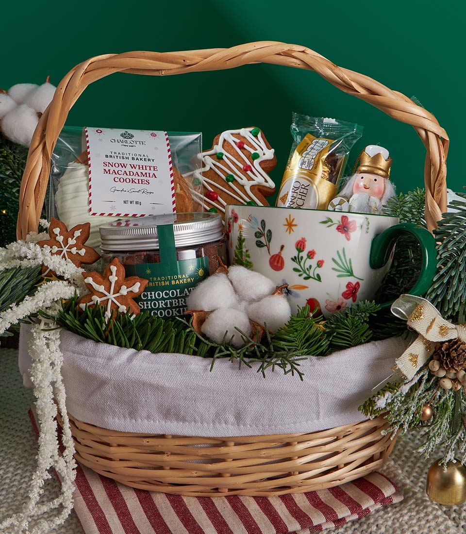 Festive Christmas gift basket with shortbread cookies, gingerbread, and holiday treats in woven wicker