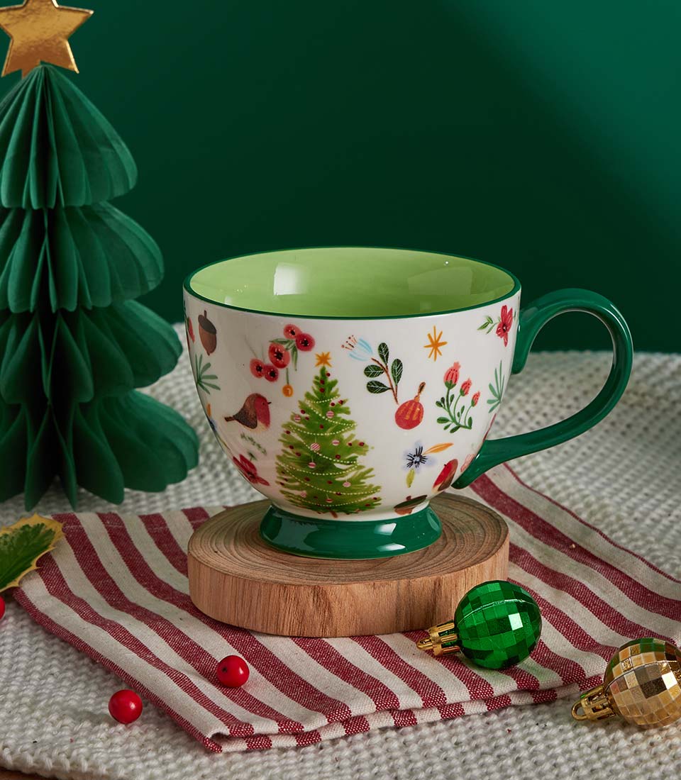 Festive ceramic mug with Christmas tree and robin design, paired with premium shortbread and gingerbread gift set