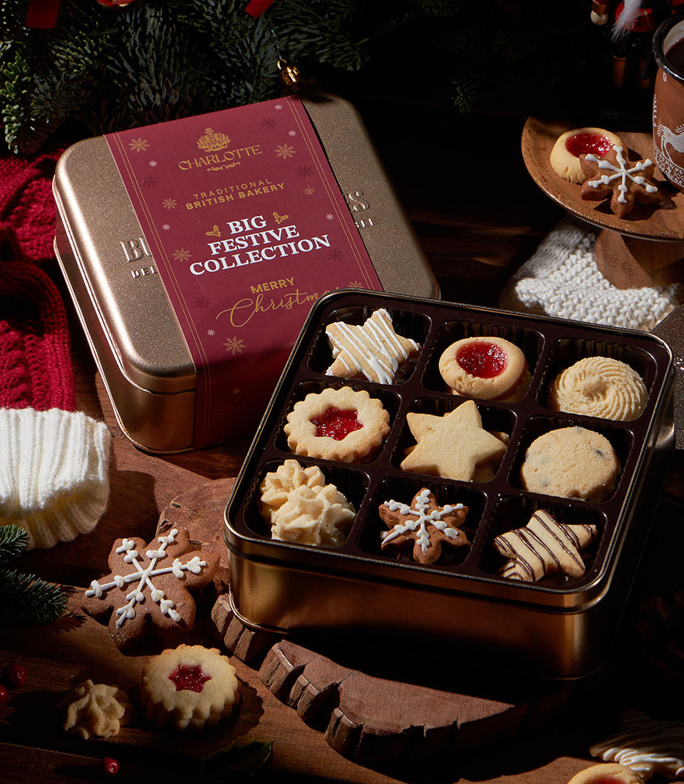 Premium festive cookie collection in gold tin with assorted Christmas cookies and snowflake designs