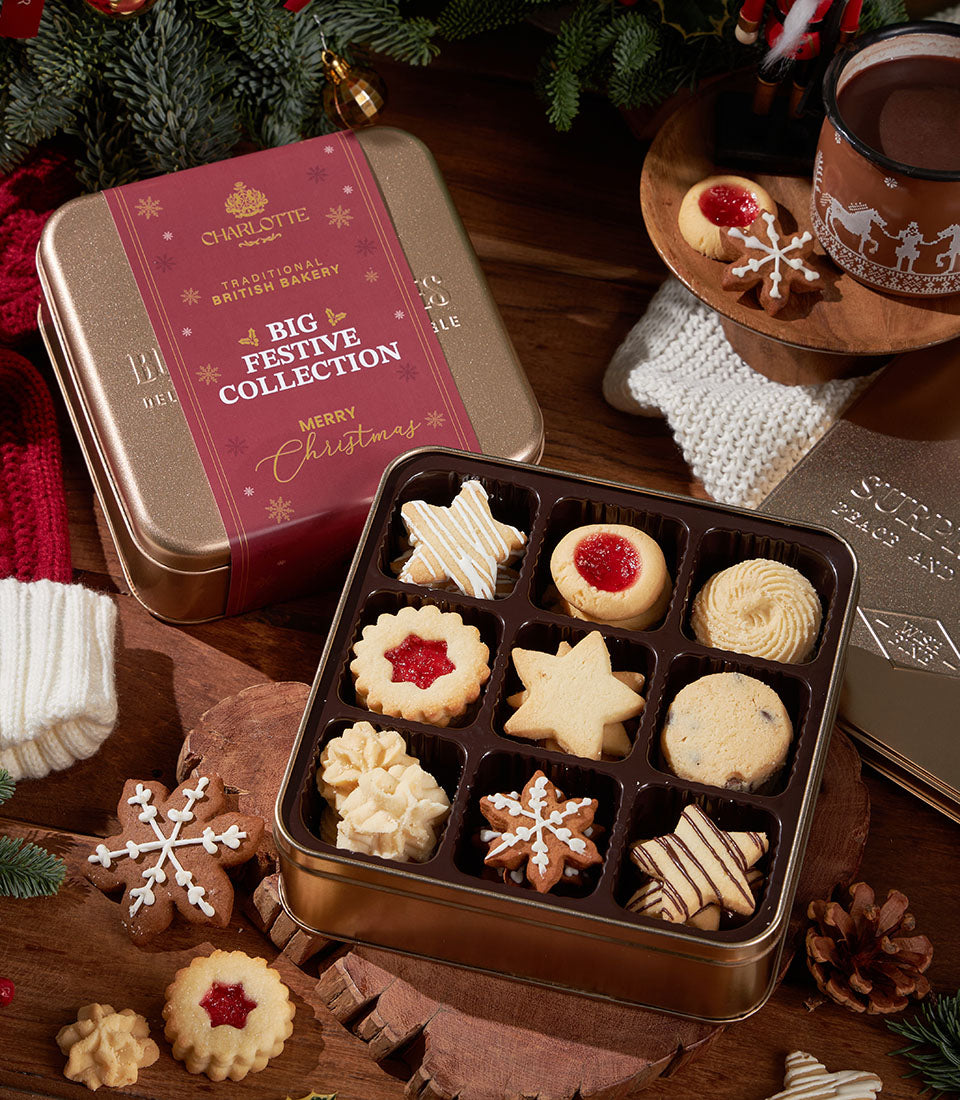 Festive British Christmas cookies assortment in golden tin with hot chocolate and holiday accents