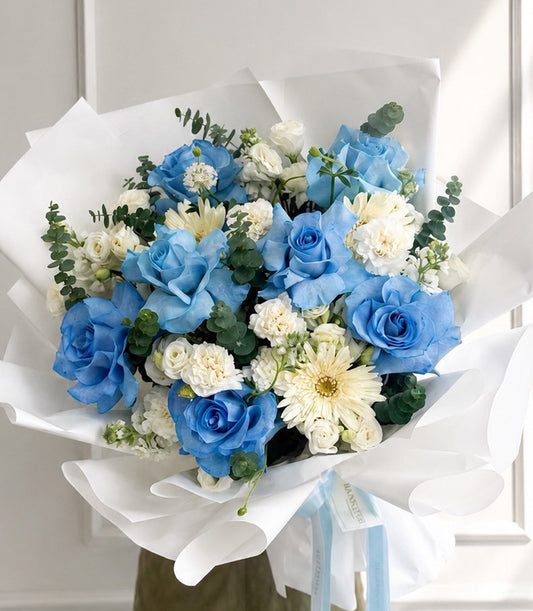 Elegant blue rose bouquet with white gerbera, spray carnations, and eucalyptus
