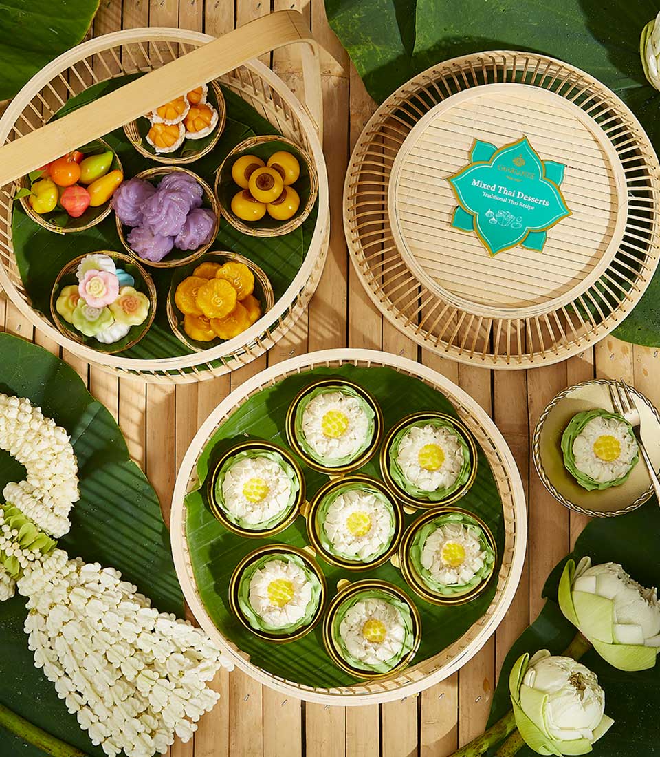 Thai Kanom Ar-Lua assorted desserts gift set with lotus and flower-shaped sweets on banana leaves