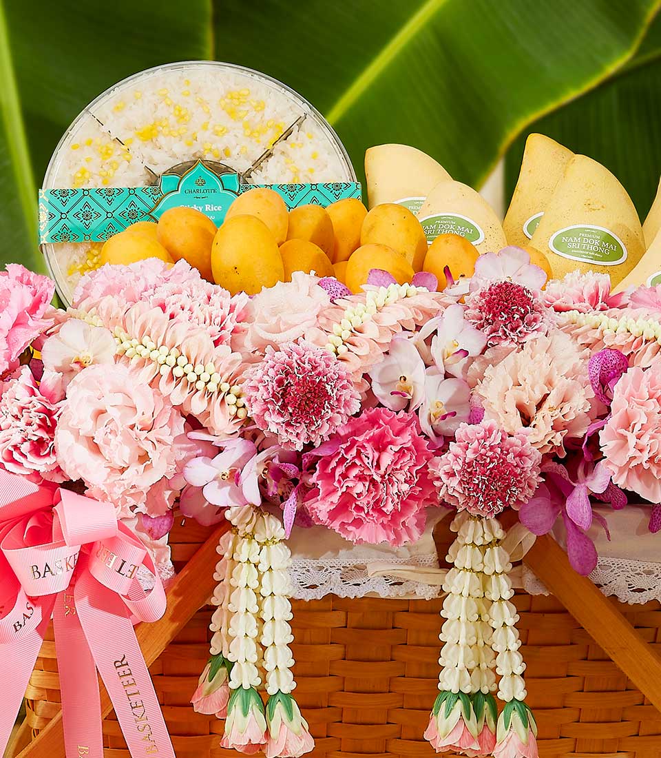 Premium Thai fruit basket with sticky rice, fresh mangoes, and pink orchids for Songkran celebration