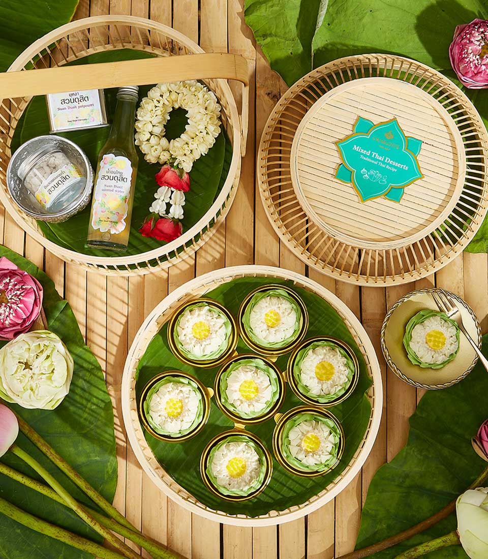 Thai Songkran gift set with lotus-shaped kanom ar-lua desserts, scented water, and fragrant potpourri on bamboo trays